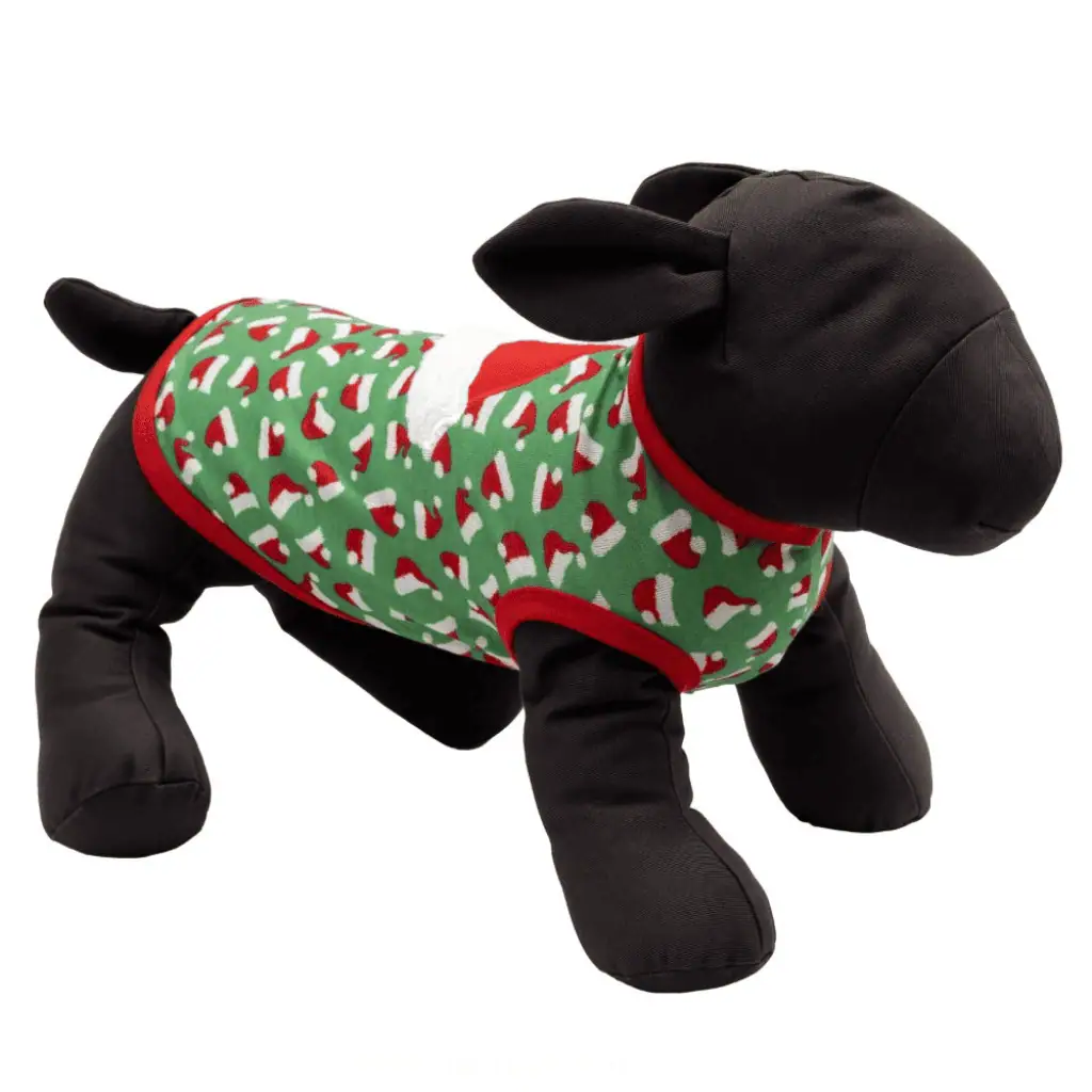 A black plush dog mannequin wearing a green dog tank with red trim with a large red Santa hat applique and red mini santa hats design