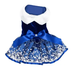 A blue velvet dog dress with blue satin underskirt, blue satin bow with rhinestone center, white collar, and snowflakes printed on tulle.