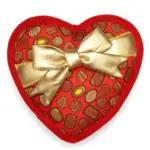 A red heart-shaped dog toy wrapped with a gold bow with mini candy chocolates design all over.